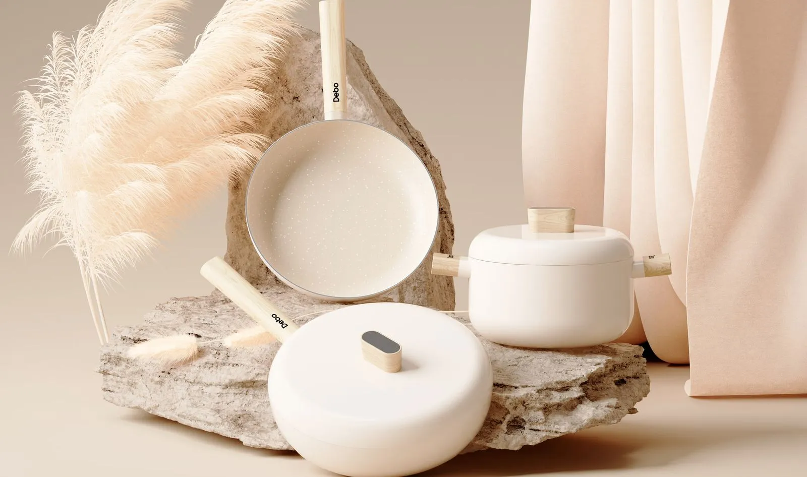 A cream Debo cookware set styled with dried grasses