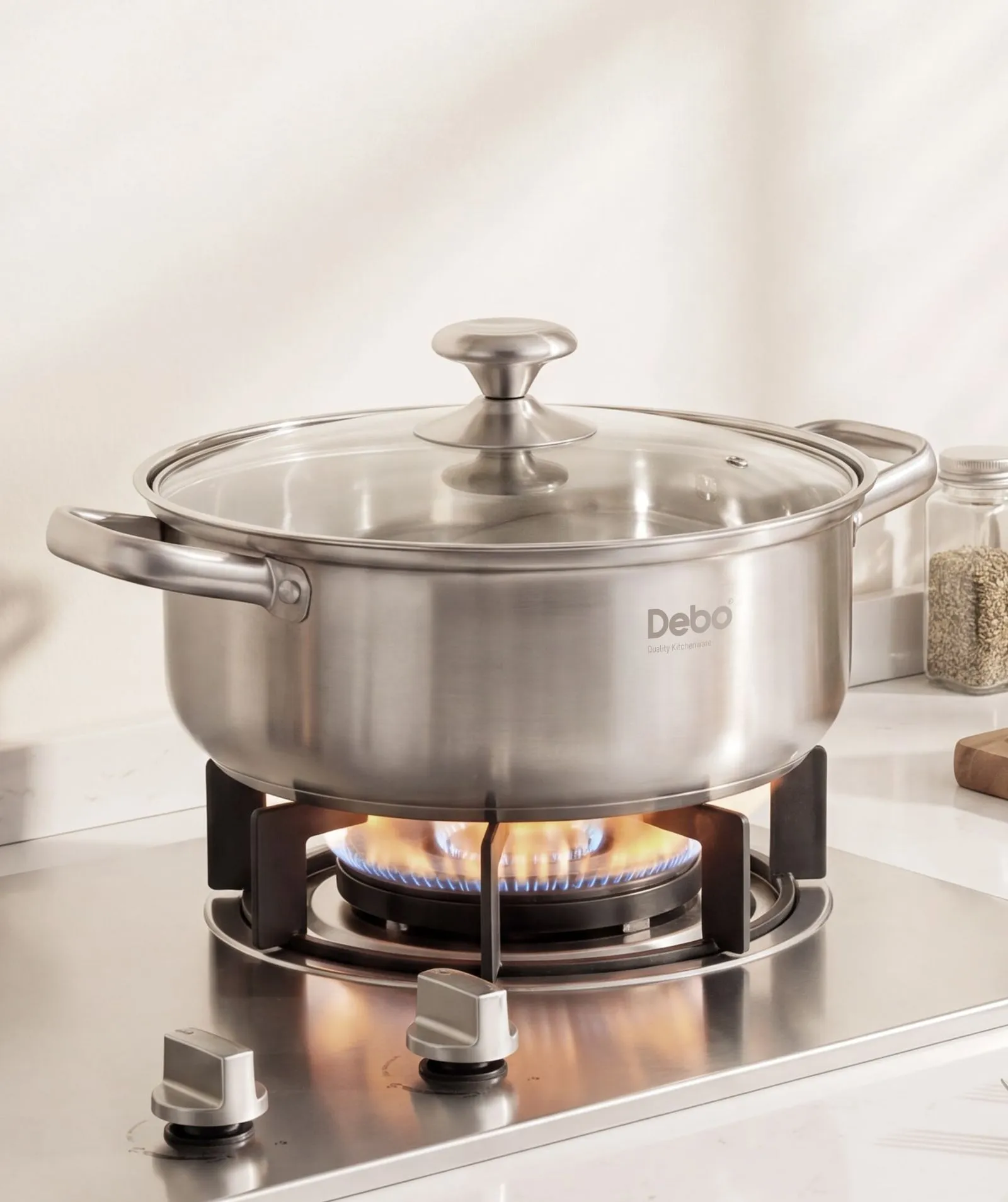 A stainless-steel soup pot heating on a gas hob